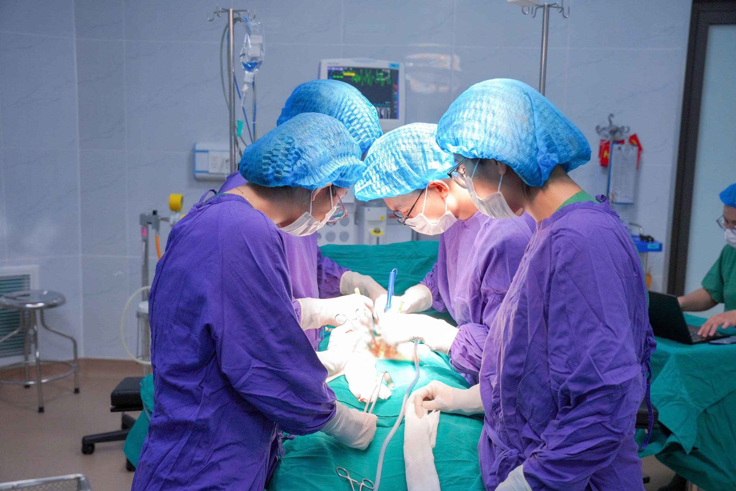 Bác sĩ phẫu thuật lấy viên sỏi ra khỏi bệnh nhân